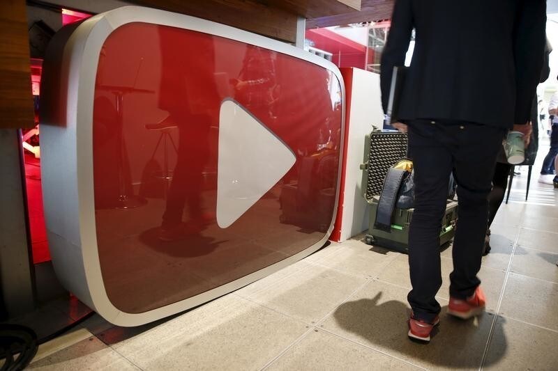 A man walks past a YouTube logo at the YouTube Space LA in Playa Del Rey, Los Angeles, California, United States October 21, 2015. Alphabet Inc's YouTube will launch a $10-a-month subscription option in the United States on October 28 that will allow viewers to watch videos from across the site without interruption from advertisements, the company said on Wednesday. REUTERS/Lucy Nicholson - RTS5JDA