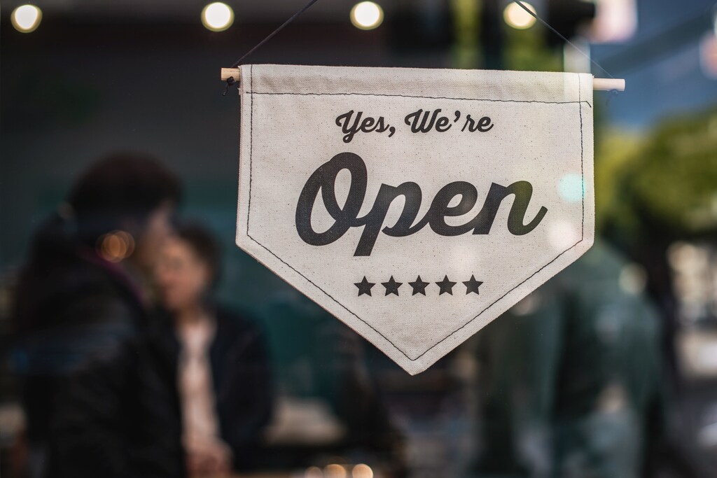 A shop sign showing "yes, we're open".