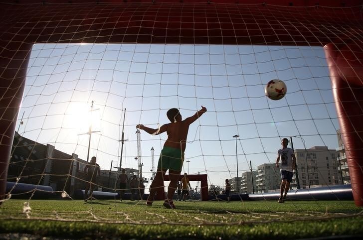 Children play soccer near the Olympic Park in Sochi, one of the host cities of the FIFA World Cup, Russia June 24, 2018. REUTERS/Francois Lenoir