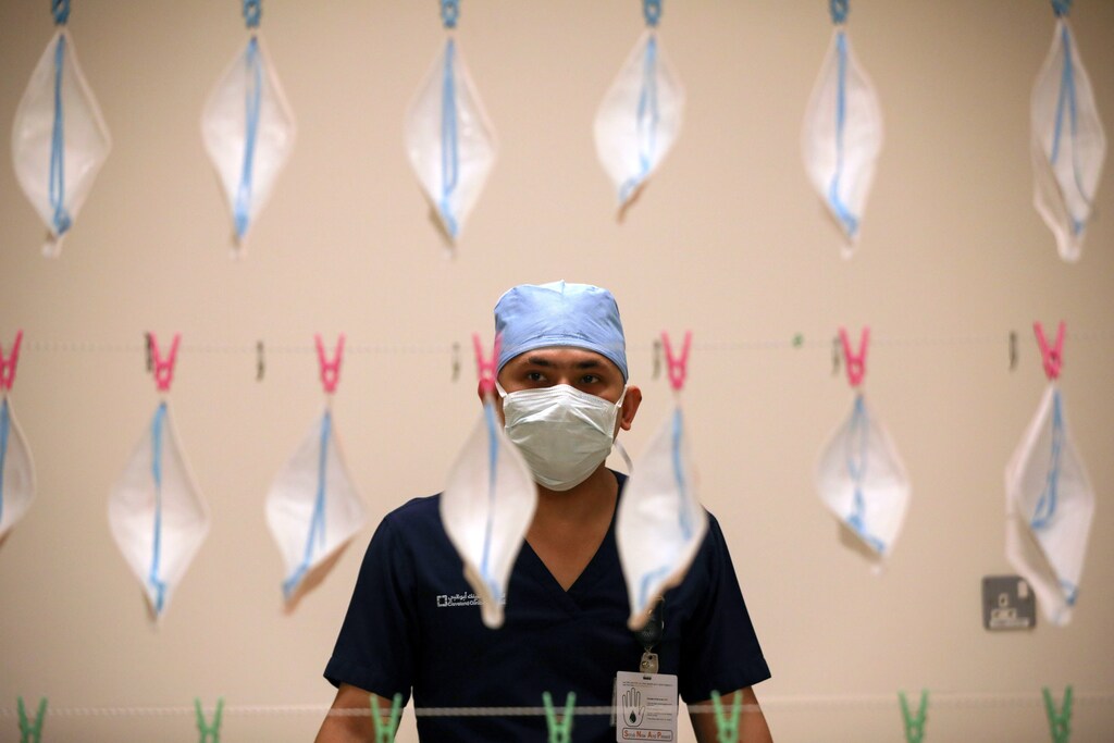 A technician hangs N95 face masks to be sterilized with UVC light, amid the coronavirus disease (COVID-19) outbreak, at the Cleveland Clinic hospital in Abu Dhabi, United Arab Emirates, April 20, 2020. REUTERS/Christopher Pike TPX IMAGES OF THE DAY - RC2J8G9H0SJD