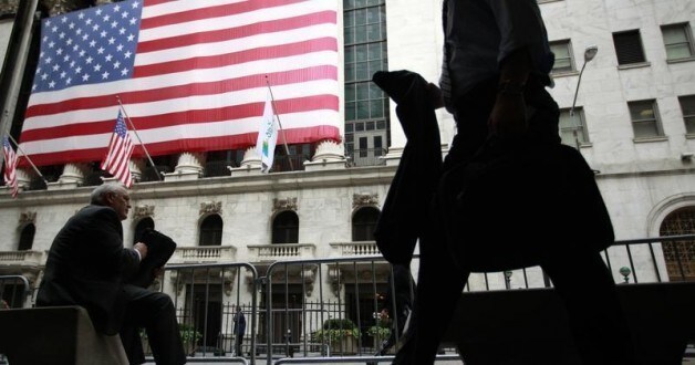 Image: Morning commuters are seen outside the New York Stock Exchange, July 30, 2012. REUTERS/Brendan McDermid.