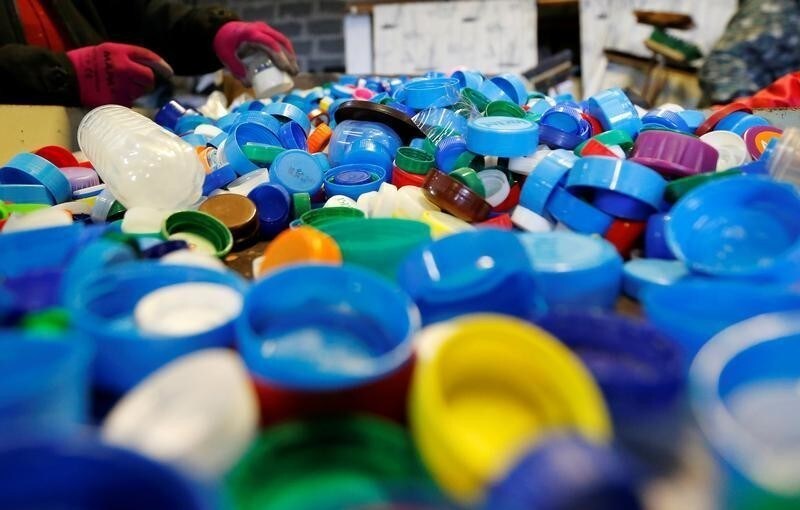 Volunteers sort caps at the Association Bouchon d'Amour which collects and recycles plastic caps in Martignas-Sur-Jalles near Bordeaux, France, November 23, 2018. REUTERS/Regis Duvignau - RC13678ECB70