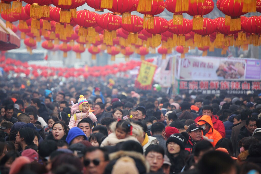 A child sitting on an adult's shoulder is seen among visitors as they flock to a temple fair on Chinese Lantern Festival on the last day of the lunar new year celebrations in Qingdao, Shandong province, China February 19, 2019. REUTERS/Stringer ATTENTION EDITORS - THIS IMAGE WAS PROVIDED BY A THIRD PARTY. CHINA OUT. - RC18E29B1810