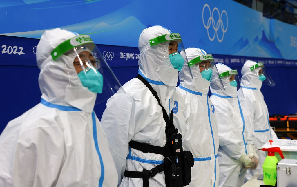 Paramedics wearing protective suits to protect from COVID-19 watch China's ice hockey team during a training session ahead of the Beijing 2022 Winter Olympics at the National Indoor Stadium in Beijing, China, 29 January, 2022.