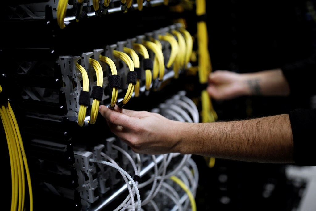Cables run into the back of a server unit inside the data center of Equinix in Pantin, near Paris, France, December 7, 2016