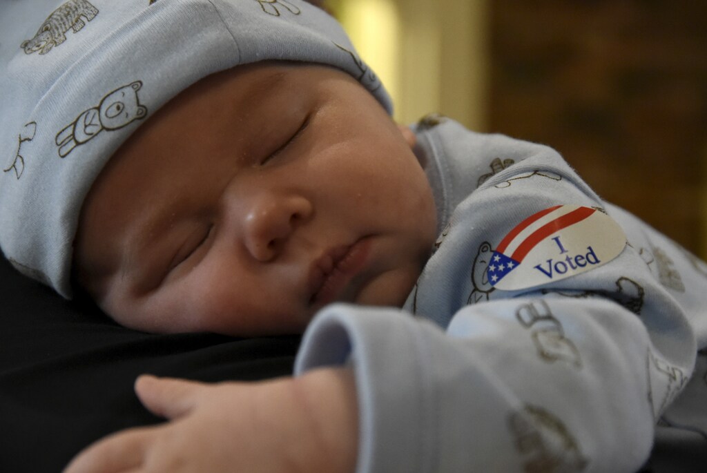 Brewer Hickman, 6 weeks old, takes a nap as his dad Nicholas Hickman votes at the North Park Mall on Super Tuesday in Oklahoma City, Oklahoma March 1, 2016. REUTERS/Nick Oxford - RTS8SMH