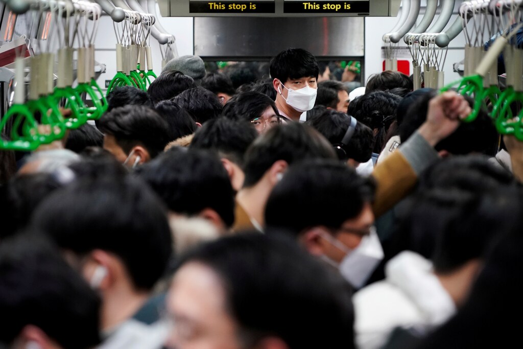 A man wearing a mask as a preventive measure against the coronavirus rides on a train in Seoul, South Korea, March 5, 2020. REUTERS/Kim Hong-Ji TPX IMAGES OF THE DAY - RC2FDF9DTFFT