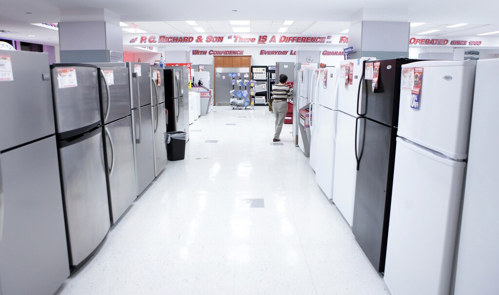 A woman walks through a display of refrigerators at a PC Richard and Son store in New York December 23, 2009. U.S. consumer spending rose in November as incomes recorded their biggest gain in six months, but a surprise drop in new home sales to a seven-month low was a reminder that the economic recovery would be bumpy. REUTERS/Lucas Jackson (UNITED STATES - Tags: BUSINESS) - RTR28BF7