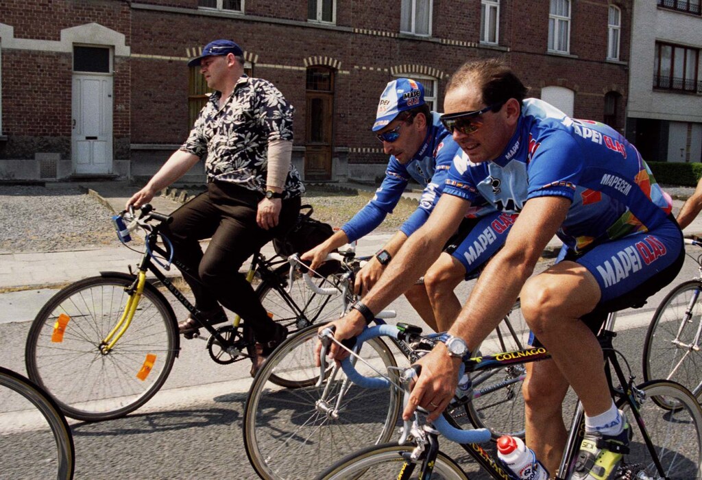 Switzerland's Tony Rominger (C) and Spanish teamate Fernando Escartin (L) overtake a Belgian cyclist during a training session in Tournai town for the 81st. Tour de France.