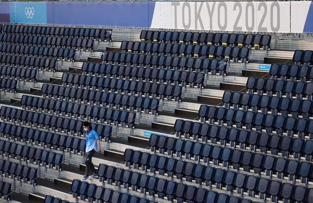 Tokyo 2020 Olympics - Beach Volleyball Training - Shiokaze Park, Tokyo, Japan - July 19, 2021 A volunteer walks in a stand REUTERS/Edgar Su - UP1EH7J0S9N29