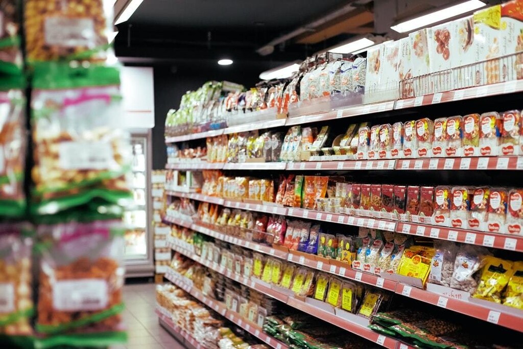 A supermarket shows food on a shelf.