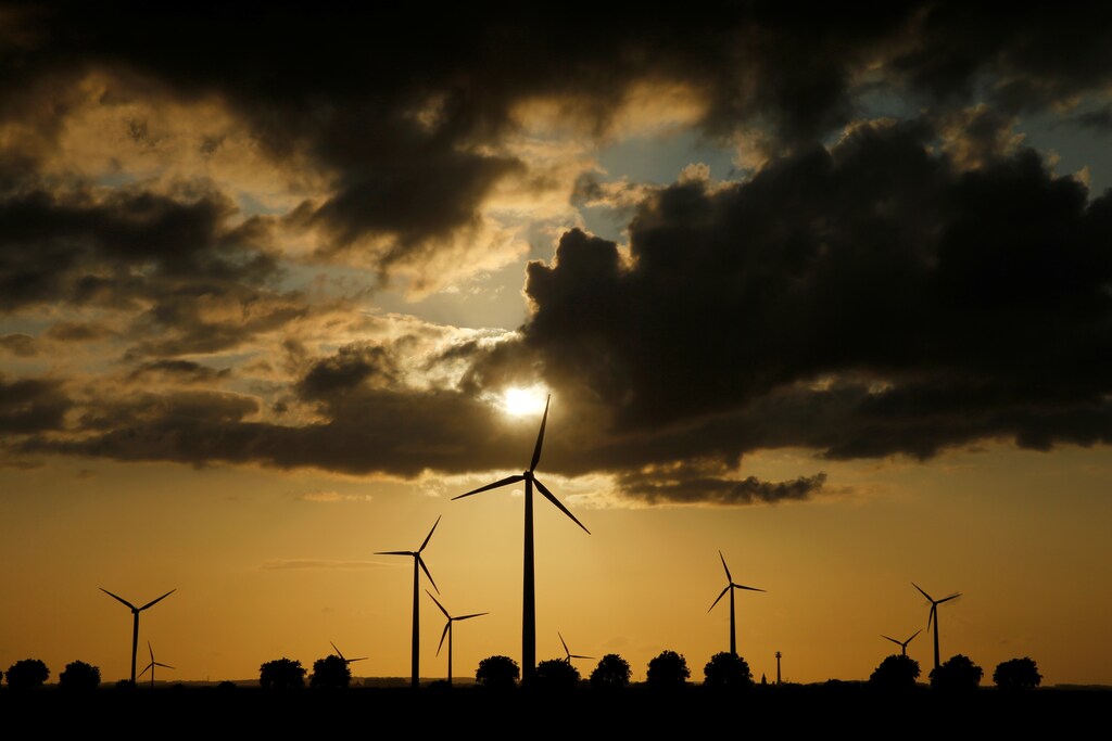 Power-generating windmill turbines are pictured during sunset at a wind park in Saint-Leger near Bapaume, France, August 18, 2019