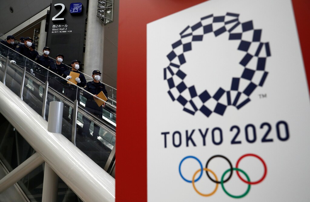 Police officers conduct a security sweep of the Tokyo Olympic Main Press Center in Tokyo, Japan July 12, 2021. REUTERS/Edgar Su - RC2QIO9X1CA1