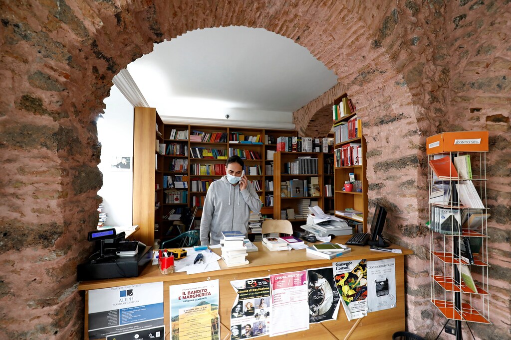 A vendor wearing a face masks stands in a store as the Italian government allows the reopening of some shops while a nationwide lockdown continues, following the outbreak of coronavirus disease (COVID-19) in Catania, Italy, April 14, 2020. REUTERS/Antonio Parrinello - RC294G99KZ61