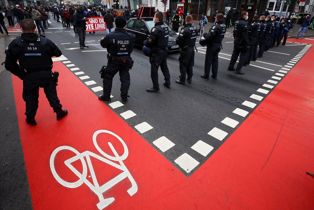 Edelman Trust Barometer: Police officers stand in line as demonstrators take part in a protest against government measures to curb the spread of COVID-19 in Frankfurt, Germany.