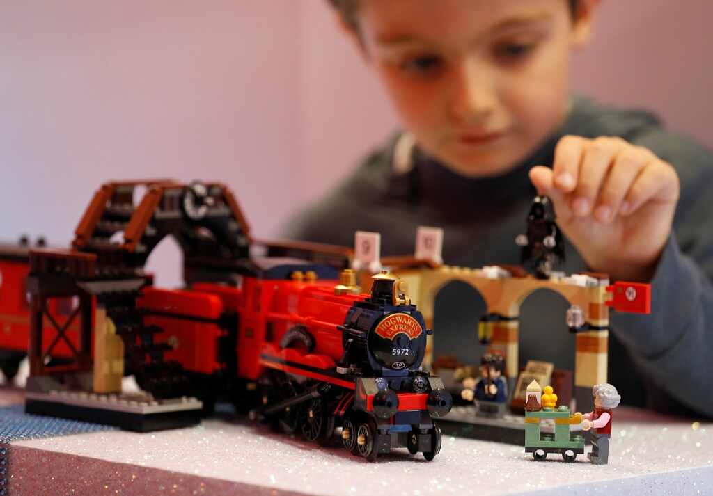 Ted Wadsworth-Hill, aged 8, plays with a Lego Harry Potter Hogwarts Express train, at the launch of Hamleys top Christmas toys in London, Britain, September 26, 2018. REUTERS/Peter Nicholls - RC1C03805540
