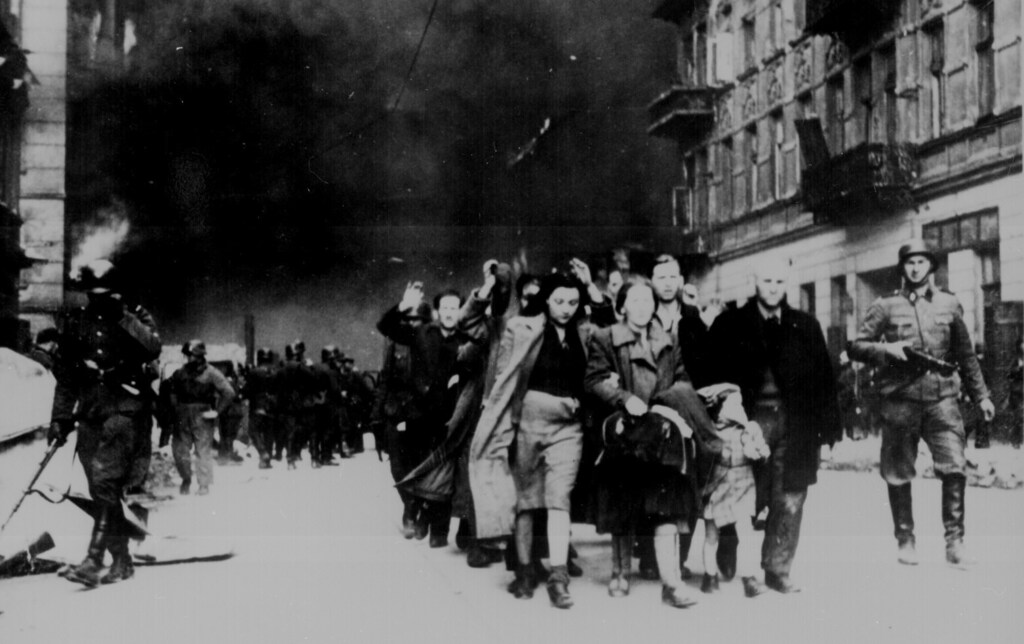 Jewish civilians are led down a street by German soldiers during the destruction of the Warsaw Ghetto, in Poland, 1943. U.S. National Archives/via REUTERS ATTENTION EDITORS - THIS IMAGE HAS BEEN SUPPLIED BY A THIRD PARTY - RC16EF750190