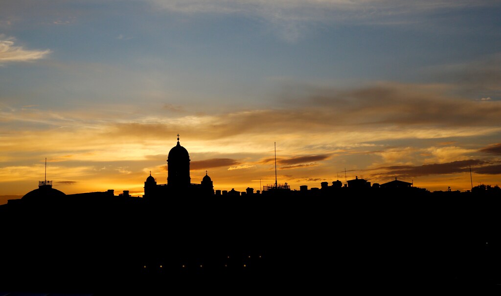 The sun sets behind the Presidential Palace and the cathedral in Helsinki, Finland July 13, 2018. REUTERS/Leonhard Foeger - RC1225267F20