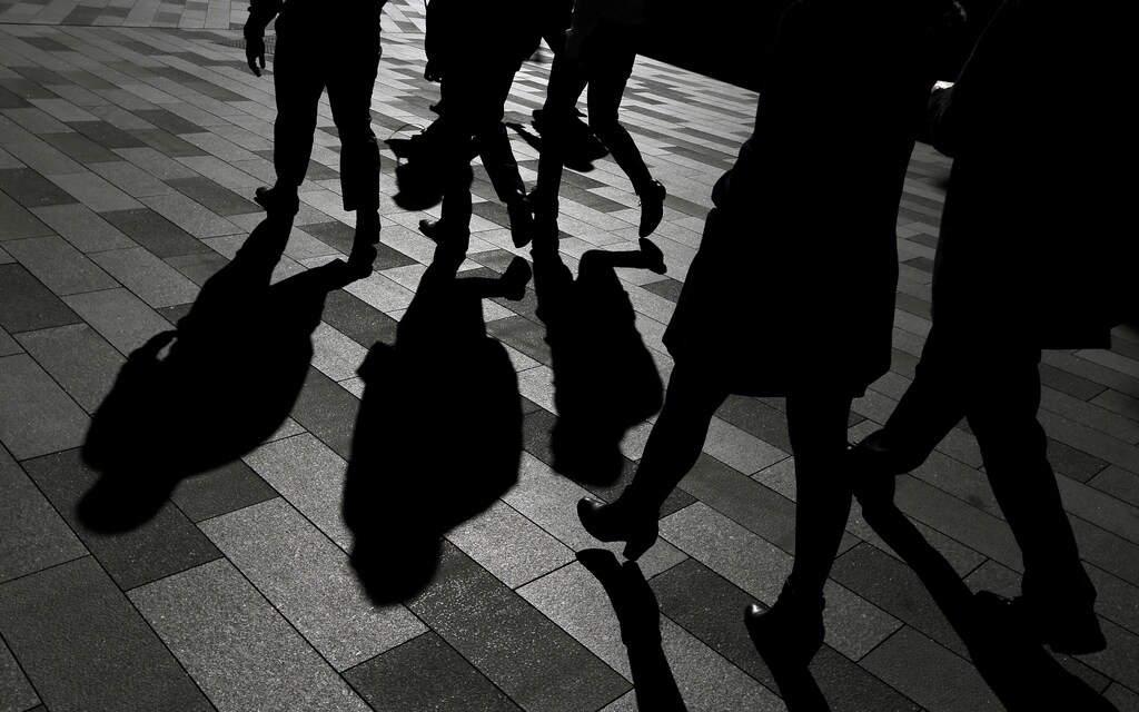 Workers cast shadows as they stroll among the office towers Sydney's Barangaroo business district in Australia's largest city, May 8, 2017. REUTERS/Jason Reed - RC174F389170
