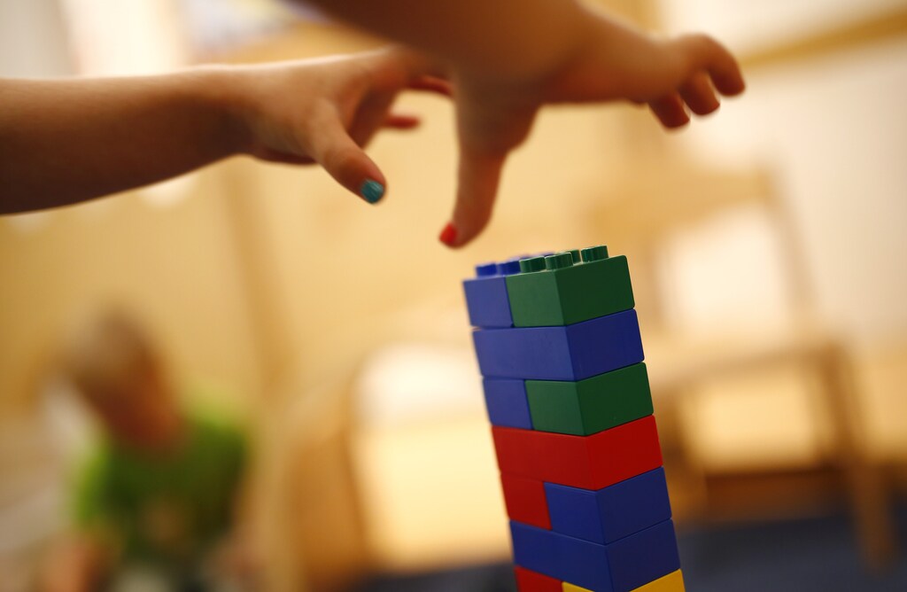 A child grabs Lego bricks at the Kathinka-Platzhoff-Stiftung Kindergarten (Kathinka-Platzhoff-foundation kindergarden) in Hanau, 30km (18 miles) south of Frankfurt, July 16, 2013. From August 1, 2013, all children in Germany between the age of 1 and 3 will have a legal entitlement to a place at a kindergarten. The Kindergarten of the Kathinka-Platzhoff-Stiftung is one of few which hosts children between the age of six month and six years. Picture taken July 16. REUTERS/Kai Pfaffenbach (GERMANY - Tags: POLITICS BUSINESS EMPLOYMENT SOCIETY EDUCATION) - BM2E97G13ZM01