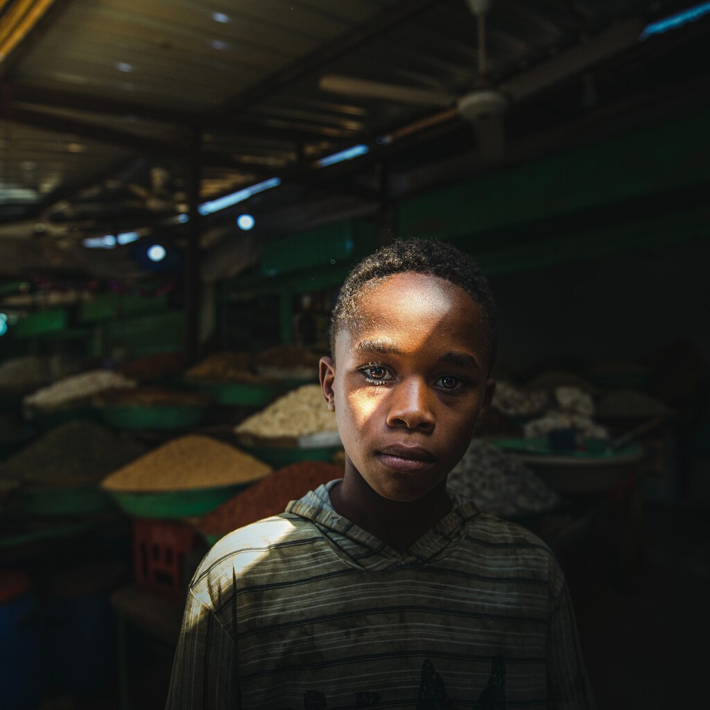 Boy stands in Sudan market selling grain: The ambition for Sudan to become a wheat exporter is unlikely to be realized with the ongoing war.