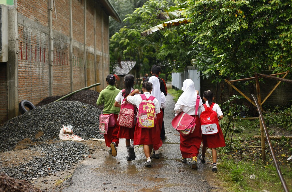 Students walk to school at Sanghiang Tanjung village in Lebak regency, Indonesia's Banten village, January 19, 2012.