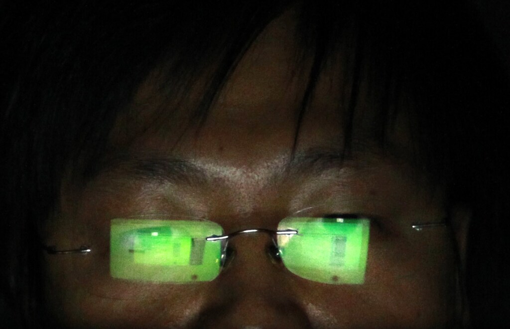 A hacker, who requests not to have his name revealed, works on his laptop in his office in Taipei July 10, 2013