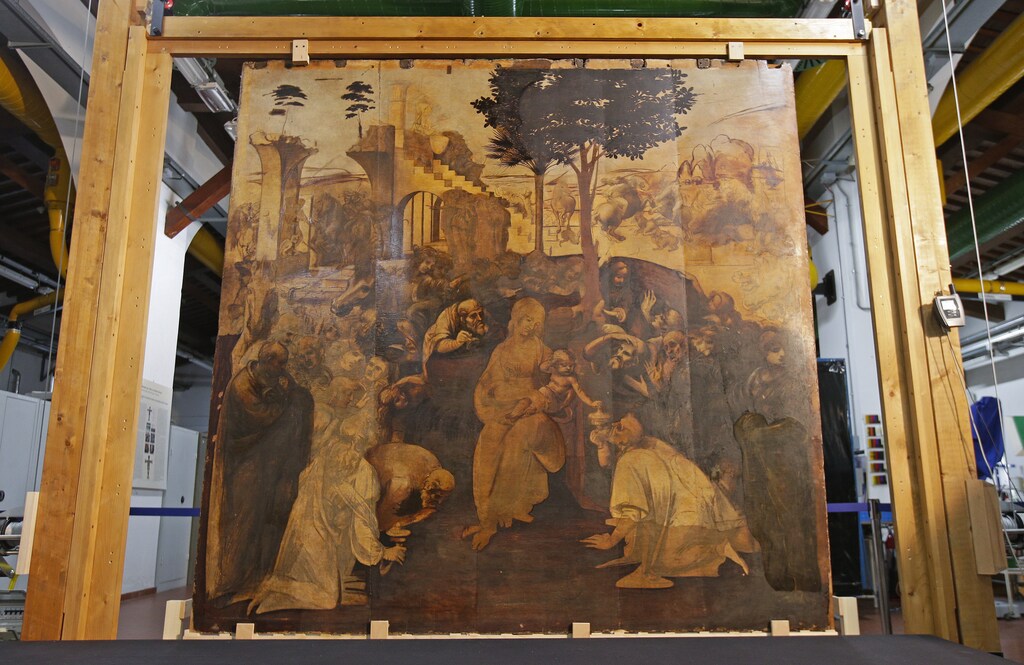 The Adoration of the Magi, a massive painting that Leonardo da Vinci started in 1481 at the age of 29 but abandoned a year later, leaving it in various stages of conception and development, is unveiled in Florence September 23, 2014. The painting on wood, measuring about 2.5 by 2.5 meters (8.2 by 8.2 feet) depicts the three wise men who paid tribute to the infant Jesus in Bethlehem, but it also includes a riot of human figures, battling horses, architectural designs, landscapes and skies. Done on 10 slabs of wood glued together, it has blank areas, areas with under-drawings, and sections in advanced stages. The current restoration project has revealed many previously hidden details, facial expressions and subtleties of light and shadow. After the wood backing of the painting is restored, it is due to return to a special room in the Uffizi, where it will be on display with two other Leonardo works. To match Feature ART-ITALY/LEONARDO Picture taken September 23, 2014. REUTERS/Max Rossi (ITALY - Tags: SOCIETY) - GM1EA9O1SGD02