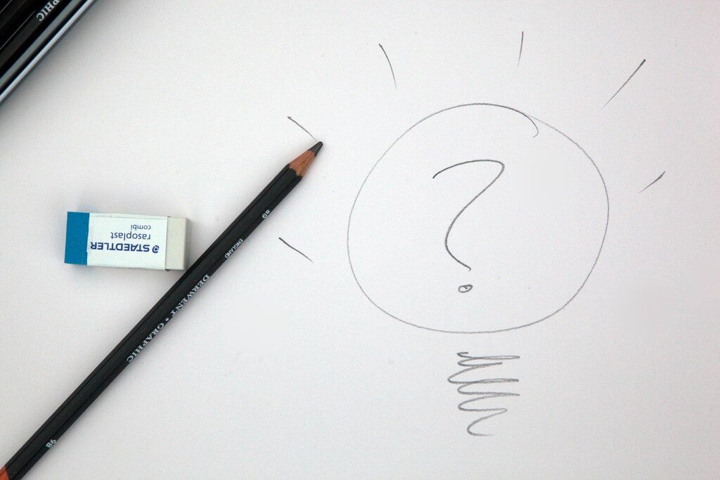 Sketch of a lightbulb with a question mark, symbolizing an idea.