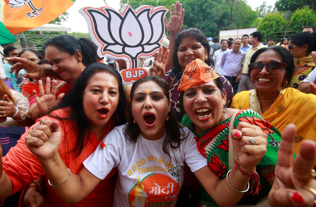 Supporters of Bharatiya Janata Party (BJP) celebrate after learning of initial poll results in Chandigarh, India, May 23, 2019. REUTERS/Ajay Verma - RC1205E41B30