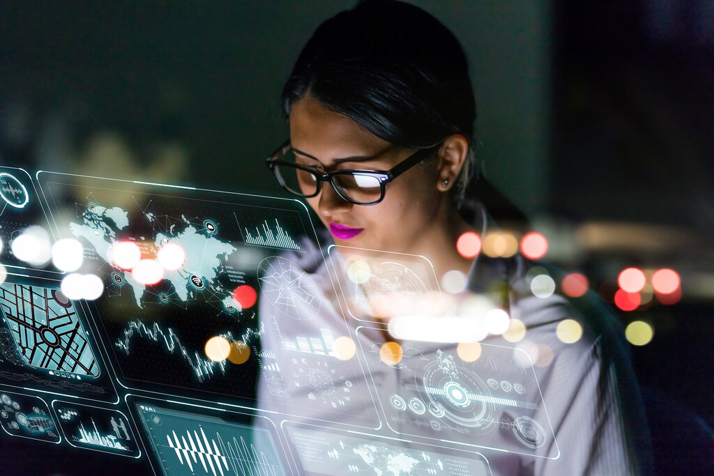A woman studies insights generated by an AI system on her computer screen.