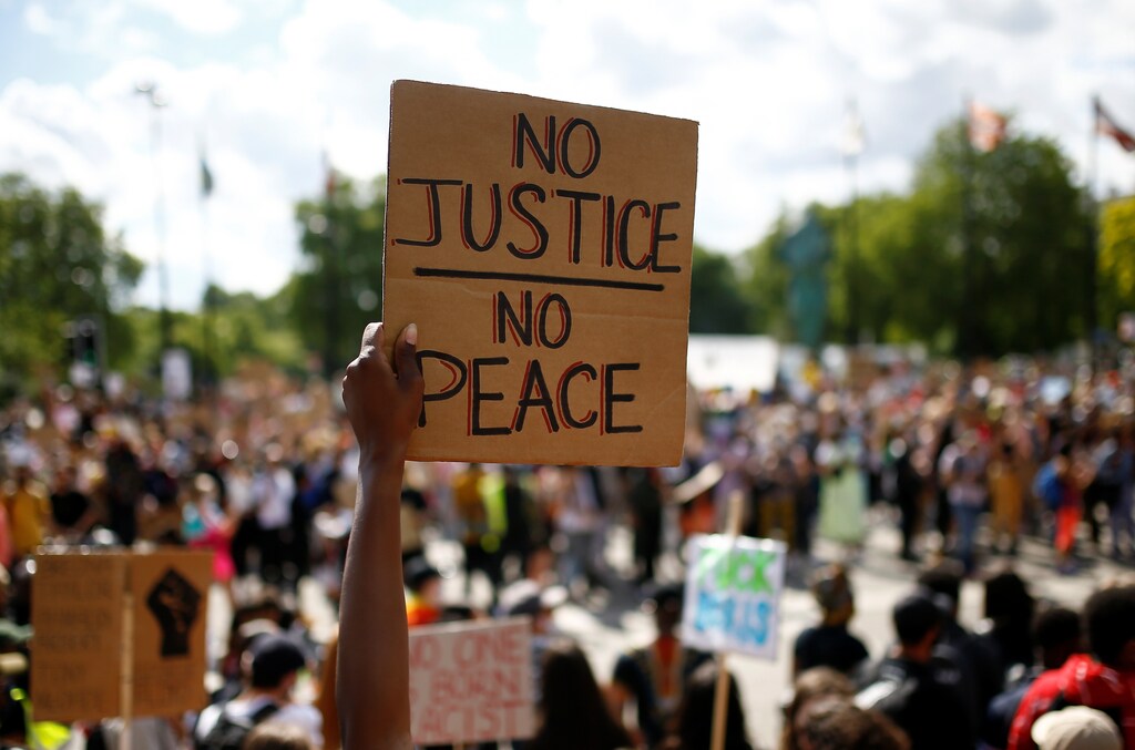 A demonstrator holds a placard as people march during a Black Lives Matter protest, following the death of George Floyd in Minneapolis police custody, in London, Britain June 20, 2020. REUTERS/Henry Nicholls - RC23DH96JAE3