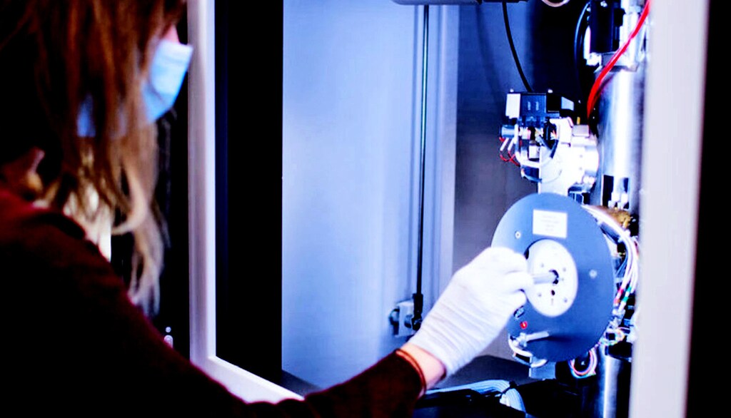 Kaitlin Brickey places a sample in the scanning electron microscope that allowed researchers to examine how dense pockets in membranes could hinder efficient water filtration efforts.