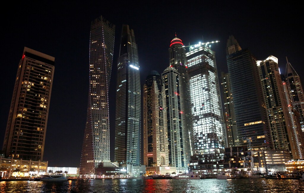 Yachts are seen at a dock at the Dubai Marina, surrounded by high towers of hotels, banks and office buildings, in Dubai, United Arab Emirates December 11, 2017. REUTERS/Amr Abdallah Dalsh - RC1D41223EB0