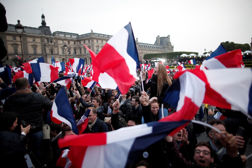 Supporters of President Elect Emmanuel Macron celebrate near the Louvre museum after results were announced in the second round vote of the 2017 French presidential elections, in Paris, France May 7, 2017. REUTERS/Benoit Tessier - RTS15K4F