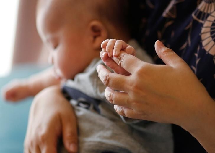 Foster mother Asako Yoshinari and her 2-month-old foster baby boy are pictured at her home in Inzai, Chiba prefecture, Japan, June 24, 2016. Picture taken June 24, 2016. REUTERS/Toru Hanai