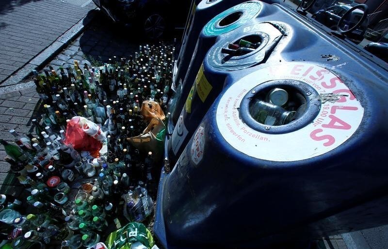 Empty glass bottles are seen beside glass recycling bins in Frankfurt, Germany, May 16, 2018. Picture taken on May 16, 2018.