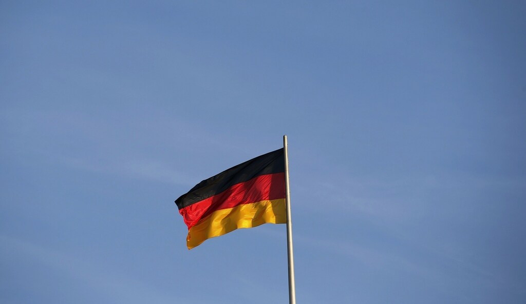 A German national flag is seen atop the Reichstag building, the seat of the German lower house of parliament Bundestag, in Berlin, November 2, 2014. REUTERS/Fabrizio Bensch (GERMANY - Tags: SOCIETY POLITICS) - RTR4CJW5