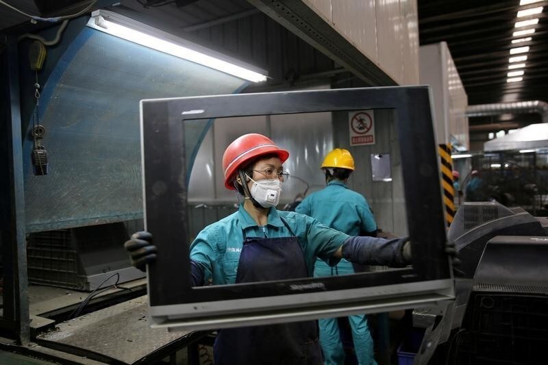 Workers dismantle used television sets at a recycling plant in Neijiang, Sichuan province, China June 11, 2018. REUTERS/Stringer ATTENTION EDITORS - THIS IMAGE WAS PROVIDED BY A THIRD PARTY. CHINA OUT. TPX IMAGES OF THE DAY - RC13F271E580