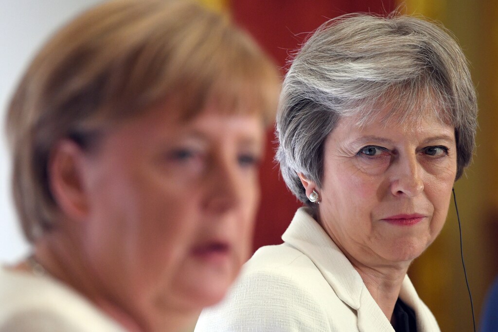 Britain's Prime Minister Theresa May, and Germany's Chancellor Angela Merkel hold a news conference with Polish Prime Minister, Mateusz Morawiecki (unseen) during the Western Balkans Summit 2018 at Lancaster House in London, Britain, July 10, 2018.Stefan Rousseau/Pool via REUTERS - RC1859EB96B0