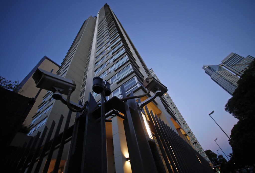 Security cameras are seen over the fence of the complex building where late prosecutor Alberto Nisman was found dead in Buenos Aires January 23, 2015.