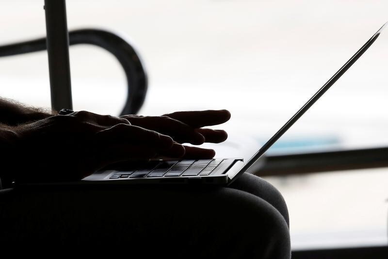 A man works with a laptop at the airport in Hanoi, Vietnam October 18, 2017. REUTERS/Kham - RC12A0E85820