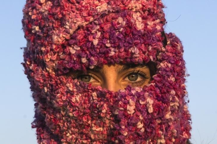 A woman from Syria looks on as she waits to cross the border with Croatia near the village of Berkasovo, Serbia, October 21, 2015. REUTERS/Marko Djurica TPX IMAGES OF THE DAY