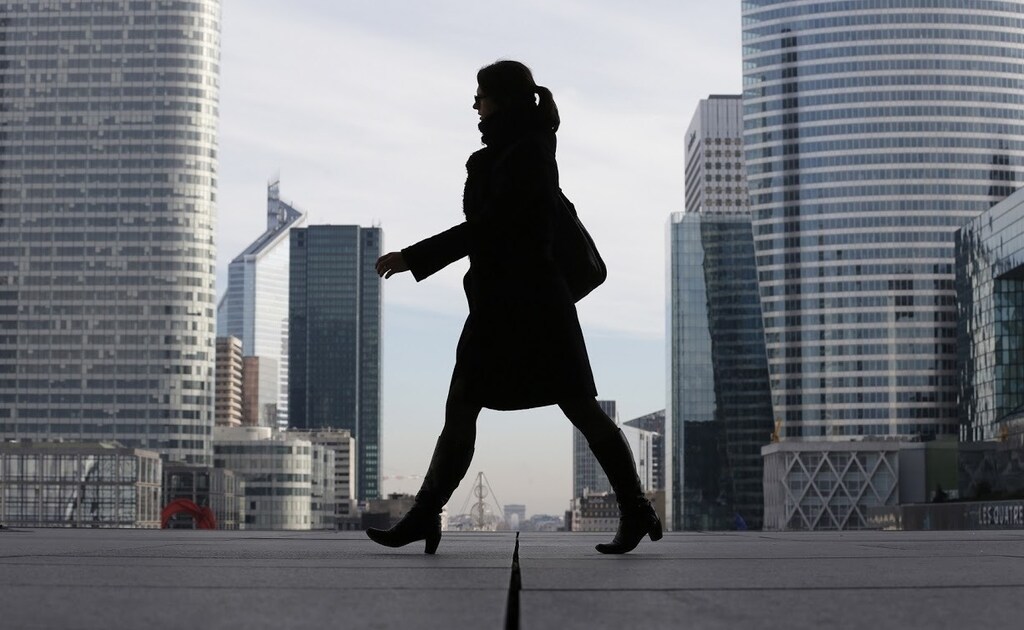 A Businesswoman is silhouetted as she makes her way under the Arche de la Defense, in the financial district west of Paris, November 20, 2012. France said its economy was sound and reforms were on track after credit ratings agency Moody's stripped it of the prized triple-A badge due to an uncertain fiscal and economic outlook. Monday's downgrade, which follows a cut by Standard & Poor's in January, was expected but is a blow to Socialist President Francois Hollande as he tries to fix France's finances and revive the euro zone's second largest economy. REUTERS/Christian Hartmann (FRANCE - Tags: POLITICS BUSINESS) - RTR3ANMB