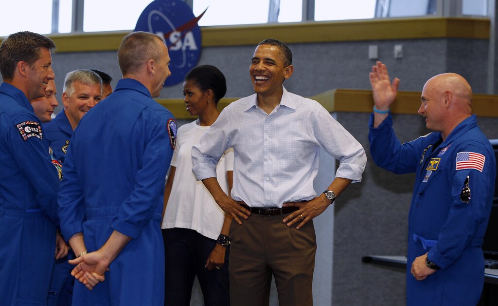 U.S. President Barack Obama, and first lady, Michelle Obama talk to the astronauts of the space shuttle Endeavour including mission commander Mark Kelly (R) after the mission was postponed at the Kennedy Space Center at Cape Canaveral, Florida, April 29, 2011. Kelly is the husband of wounded U.S. Rep. Gabrielle Giffords (D-AZ) who is also in Florida to watch the lift off. REUTERS/Larry Downing (UNITED STATES - Tags: POLITICS SCI TECH) - RTR2LSDY