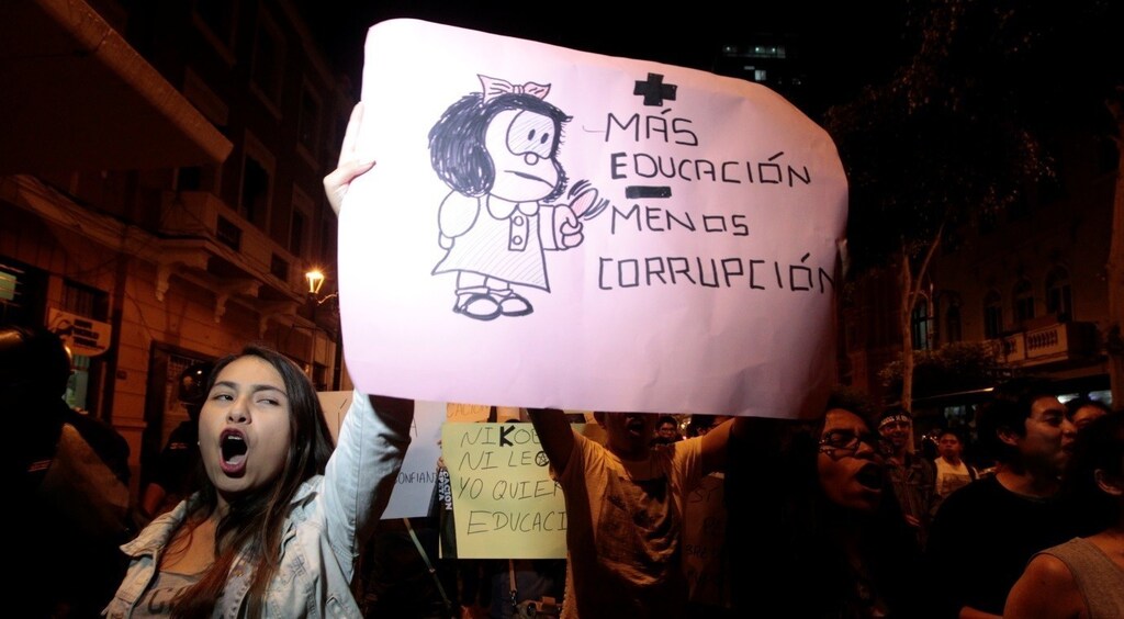 Protesters hold a sign reading "More education less corruption" to protest against a plan by opposition lawmakers to oust Peru's Education Minister Jaime Saavedra in Lima, Peru, December 12, 2016