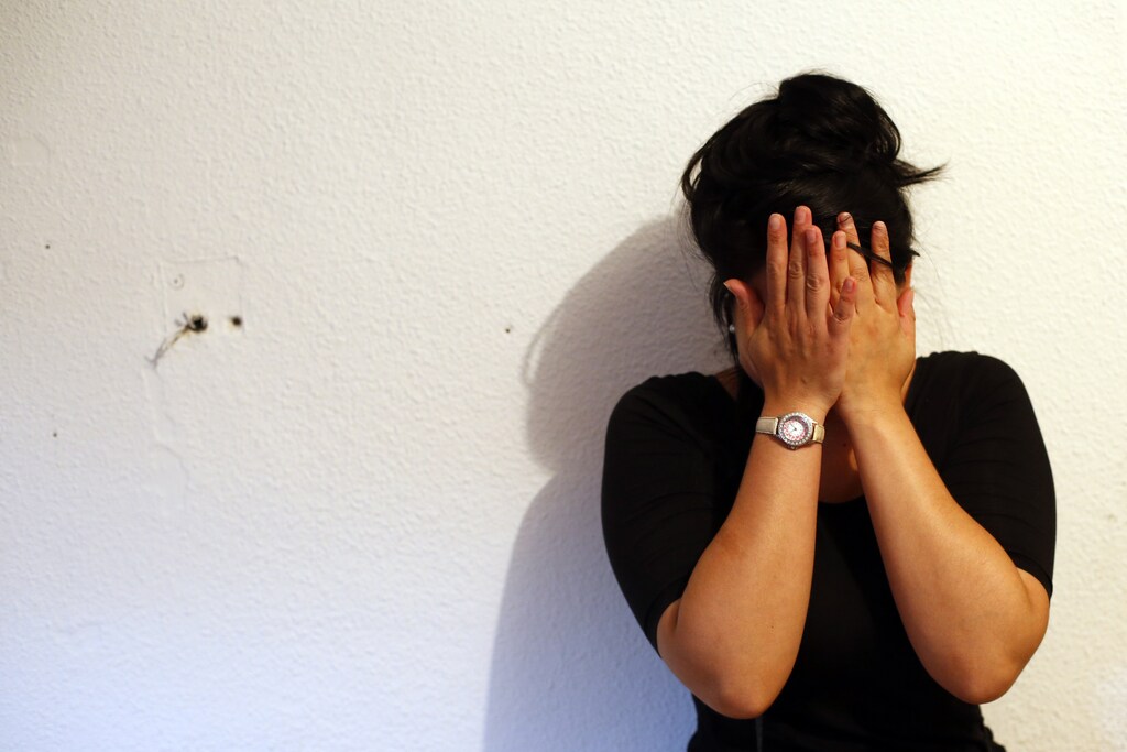 Susana Santiago Montoya cries in her apartment as her eviction is carried out in Madrid July 24, 2013. Santiago Montoya, 26, her husband Angel Gimenez de la Rosa, 26, and their two sons (10 and 7 years old) had been squatting for the past year in a social rent flat of the Municipal Housing and Land Company (EMVS) in Madrid. Unemployed and unable to afford rent, Santiago and Gimenez de la Rosa resorted to occupying a two-bedroom apartment that had gone vacant. Several activists were detained as they were trying to stop the eviction, which ended up being carried out despite their efforts to stop it. REUTERS/Susana Vera (SPAIN - Tags: CIVIL UNREST SOCIETY POLITICS BUSINESS REAL ESTATE) - GM1E97O1QW701