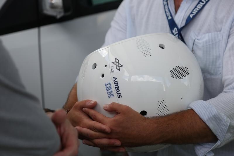 Airbus engineer Philipp Schulien holds a clone of an artificial intelligence bot named CIMON at the NASA News Annex in Florida, U.S., June 28, 2018. Picture taken on June 28, 2018.