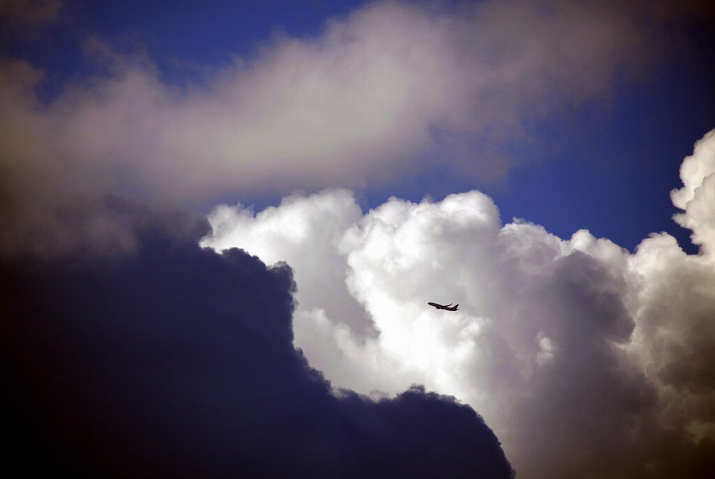 A Qantas Boeing 737-800 aircraft flies through clouds after taking off from Sydney airport February 19, 2013. Australia's Qantas Airways Ltd said compensation paid to it by Boeing over delays to the delivery of its troubled 787 aircraft totalled more than A$300 million ($308.7 million), including A$125 million in cash recorded in its first half results. Qantas Chief Financial Officer Gareth Evans announced that underlying profit before tax for the six months to December was A$223 million, compared with A$202 million a year ago. Picture taken February 19, 2013. REUTERS/David Gray (AUSTRALIA - Tags: TRANSPORT BUSINESS) - GM1E92L0K2K01