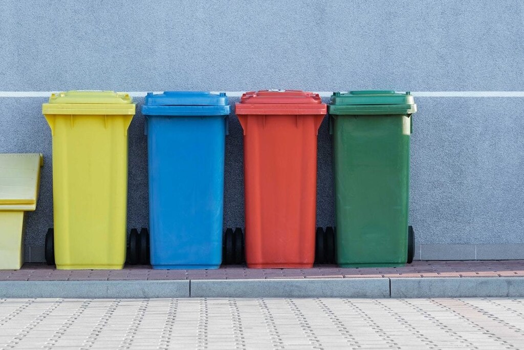Four bins, of varying colours, are lined up.